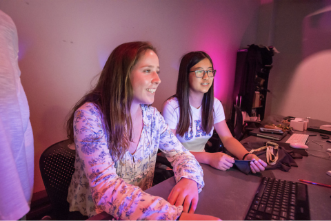 girls looking happily at the screen