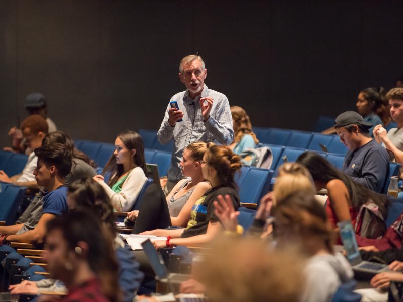 Professor with students in lecture hall